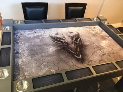 Origins Game Table with dragon template graphic on playing surface